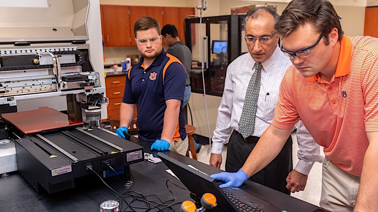 Pradeep Lall, center, monitors students in his lab.