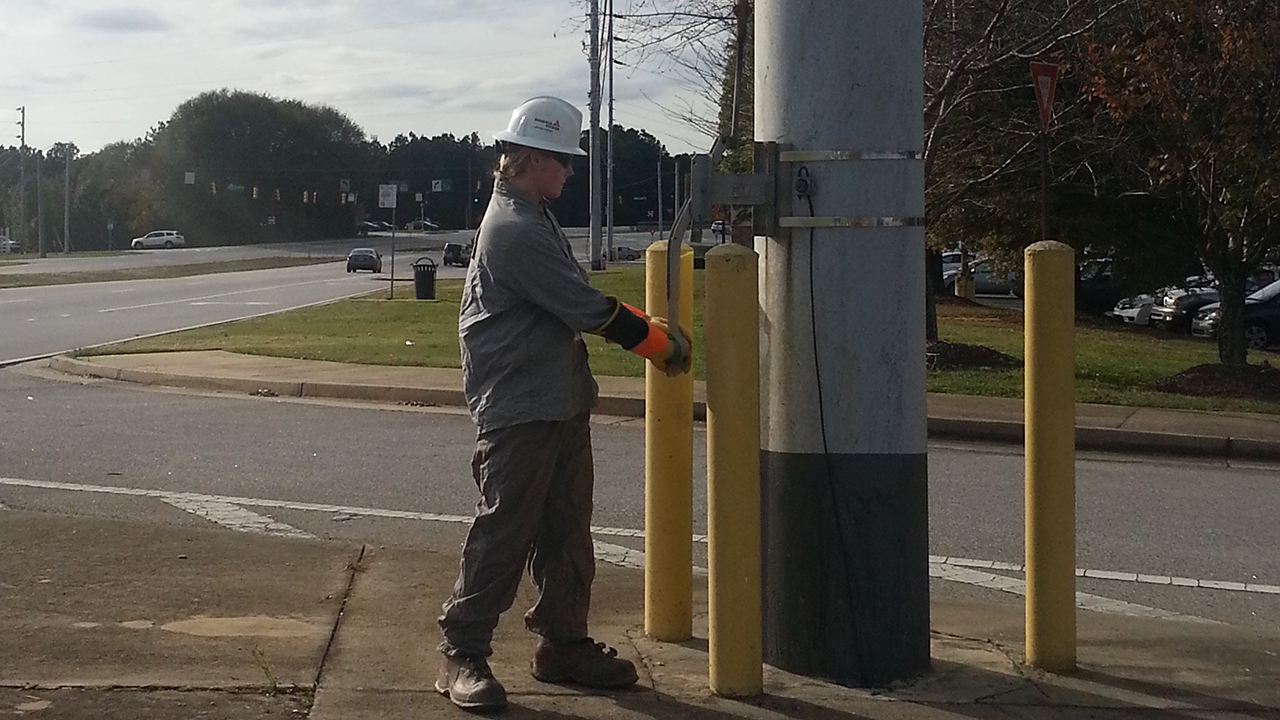 Daylon Hester closes a gang switch to tie two substations together during his co-op with Georgia Power Co.