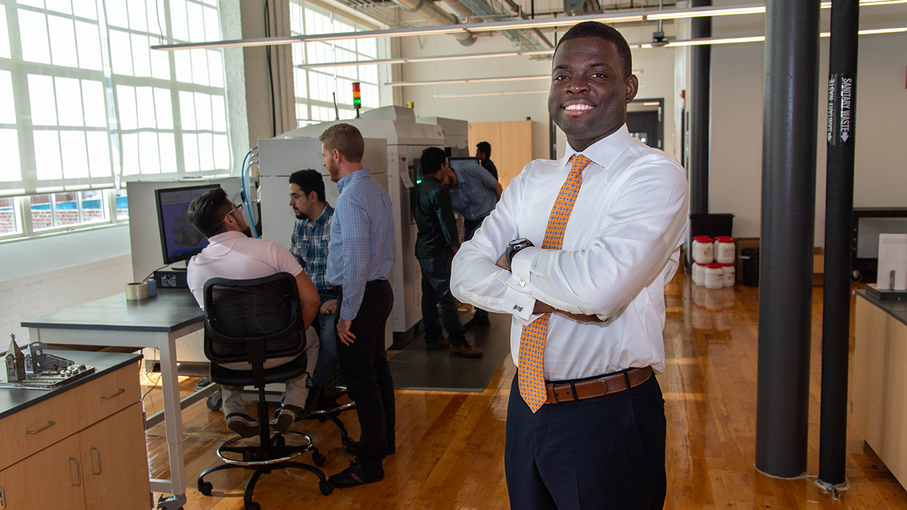 Emmanuel Winful is pictured in the Gavin Engineering Research Laboratory with researchers in the National Center for Additive Manufacturing Excellence.