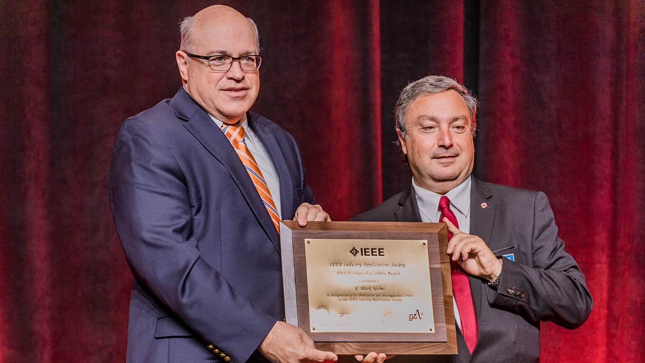 Mark Nelms (left) receiving the IEEE Industry Application Society's Service Award. 