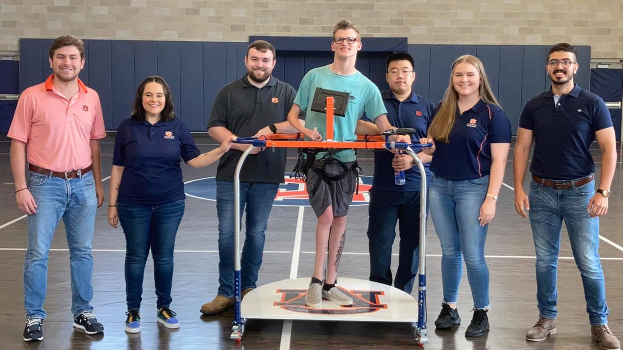 The Skate Mate mechanical engineering senior design team poses with client Jacob Carroll (center).