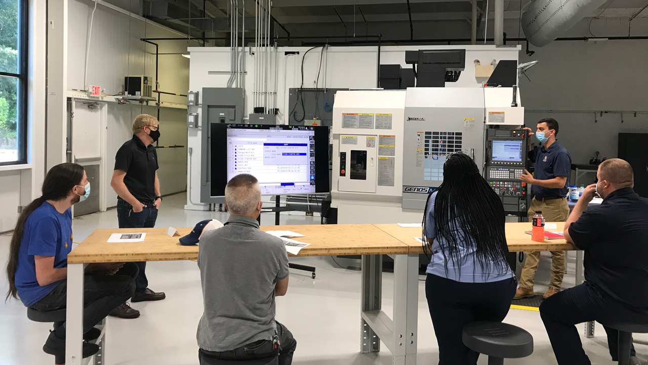 Auburn Engineering graduate assistants conduct a training session at the Auburn Advanced Manufacturing Training Center.