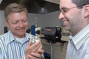 Duke and Byrne examining a metal component