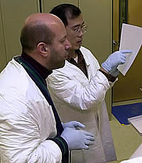 Two scientists examining paper.