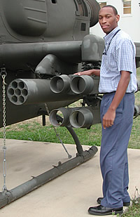Joseph Moore standing with a gun on a chopper