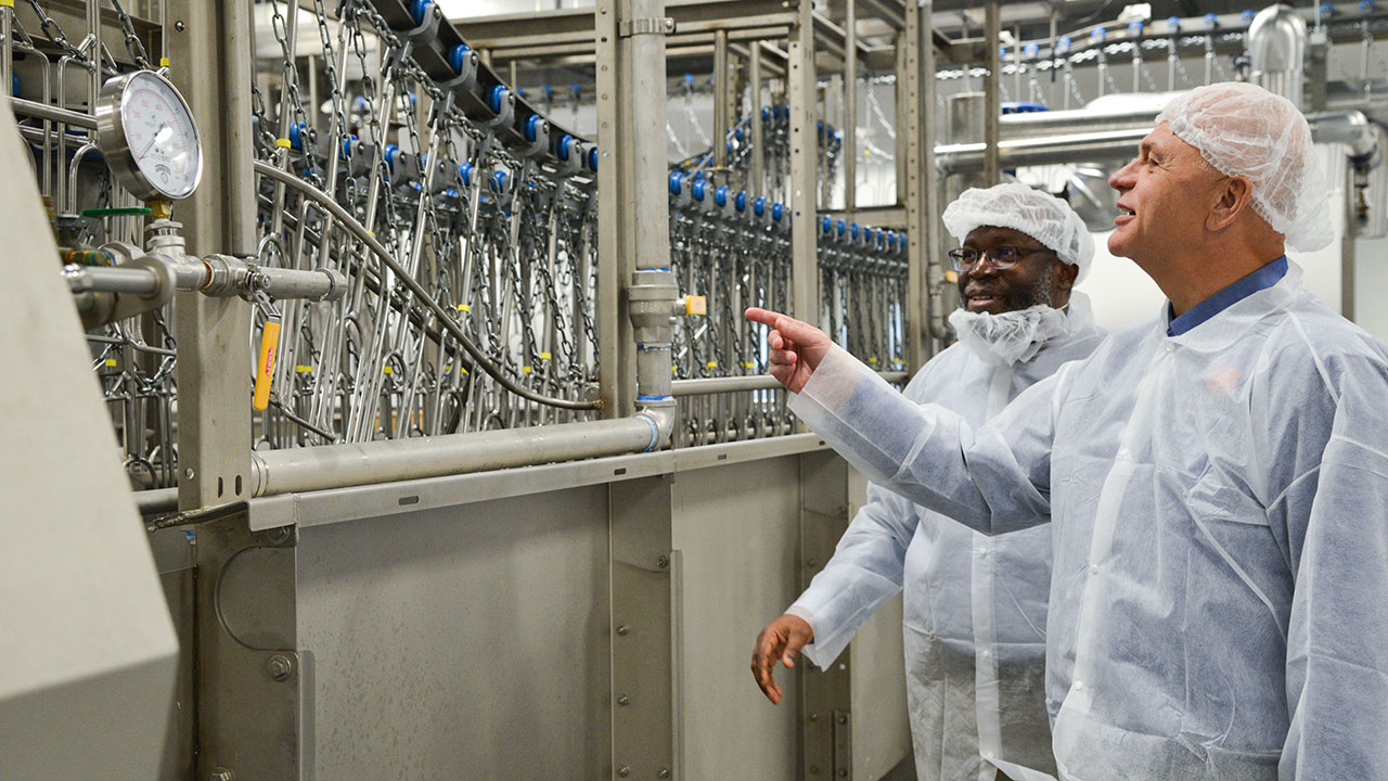 Auburn University biosystems engineering department chair Oladiran Fasina and poultry science department chair Bill Dozier, both principal investigators on the Institute for Rural Partnership project, visit the processing plant at the university’s Miller Poultry Research and Education Center.