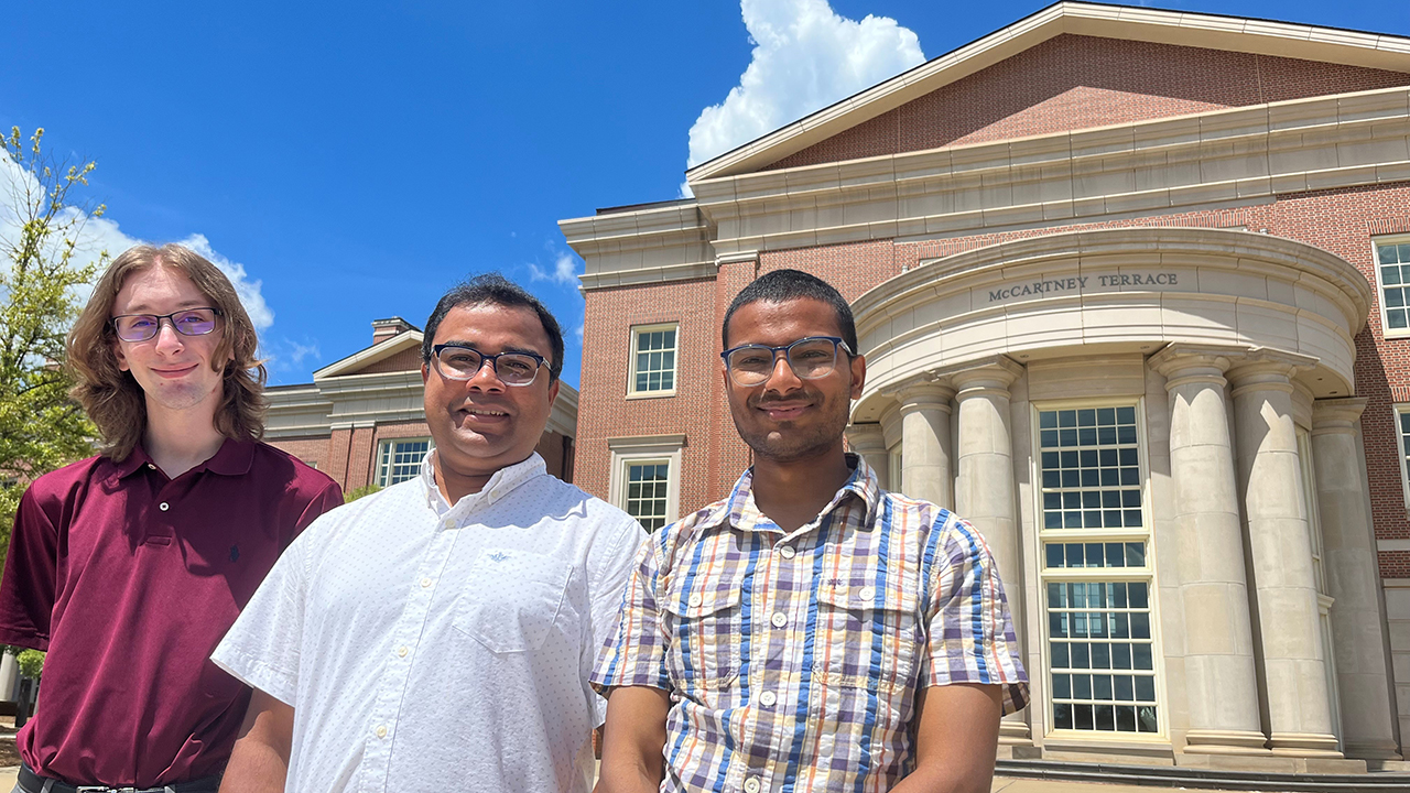 Computer science and software engineering doctoral students Alex Knipper, left, and Namal Bansal, right, with assistant professor ShubhraKanti "Santu" Karmaker, center.