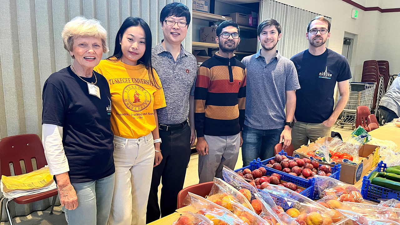 A team of researchers from Auburn University and Tuskegee University are giving back to the community by solving inventory issues and helping distribute produce. Photographed, from left to right, are volunteer Marjorie Ann Ellisor, professor Rui Chen from Tuskegee University,  assistant professor in electrical engineering Yin Sun, PhD candidate Md Kamran Chowdhury, PhD student Thomas Orrison, and Auburn United Methodist Church Mission Outreach Coordinator Joe Davis.