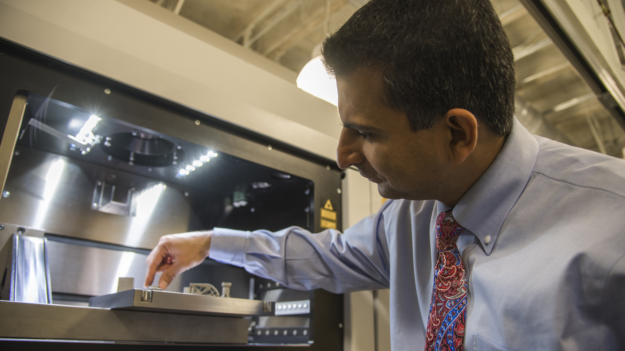 Nima Shamsaei, director of Auburn's National Center for Additive Manufacturing Excellence, oversees 3-D printing in the lab.