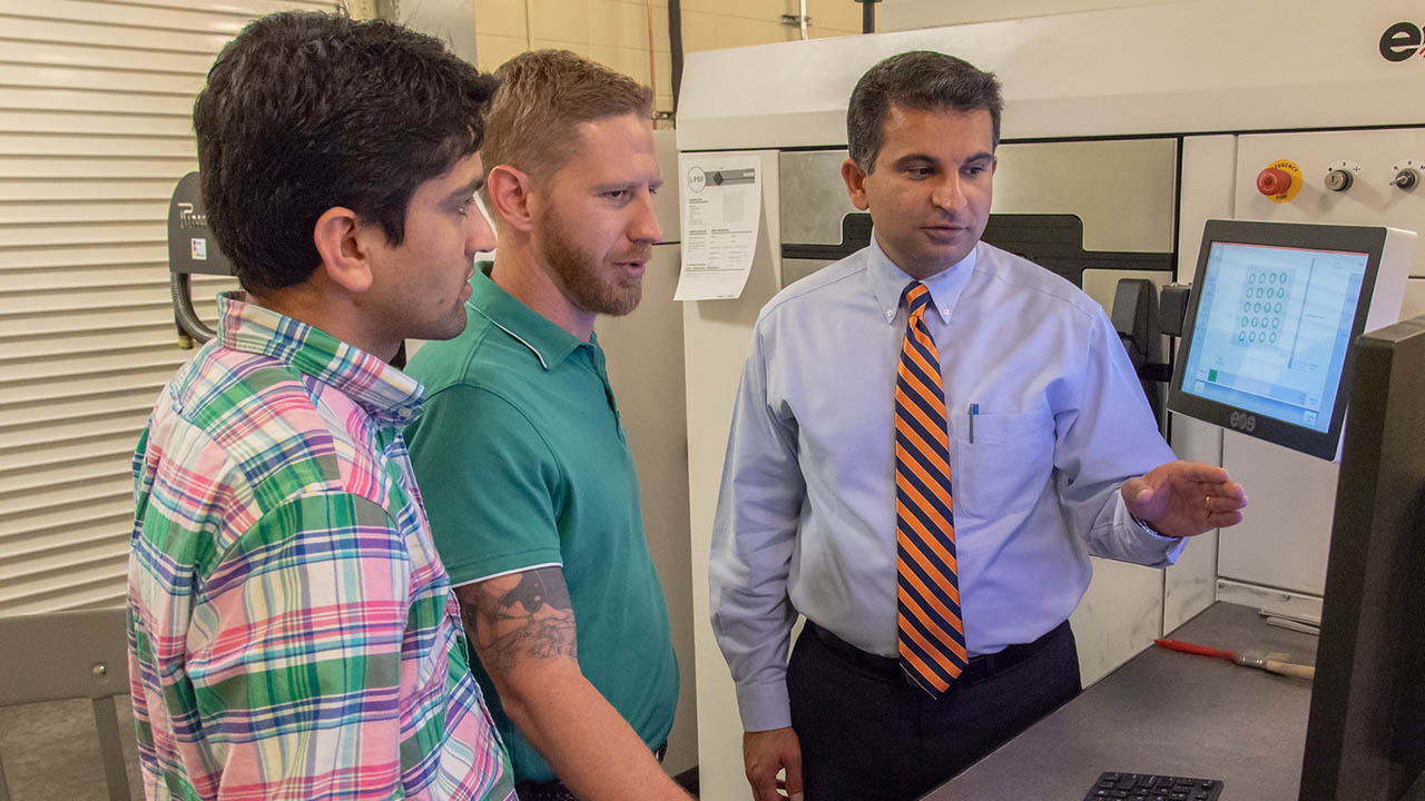  (Shown from left) Mechanical engineering doctoral students Basil Paudel and Jonathan Pegues look at a 3-D computer-aided design model with Nima Shamsaei, director of the National Center for Additive Manufacturing Excellence, in the additive manufacturing lab in Wiggins Hall at Auburn University.