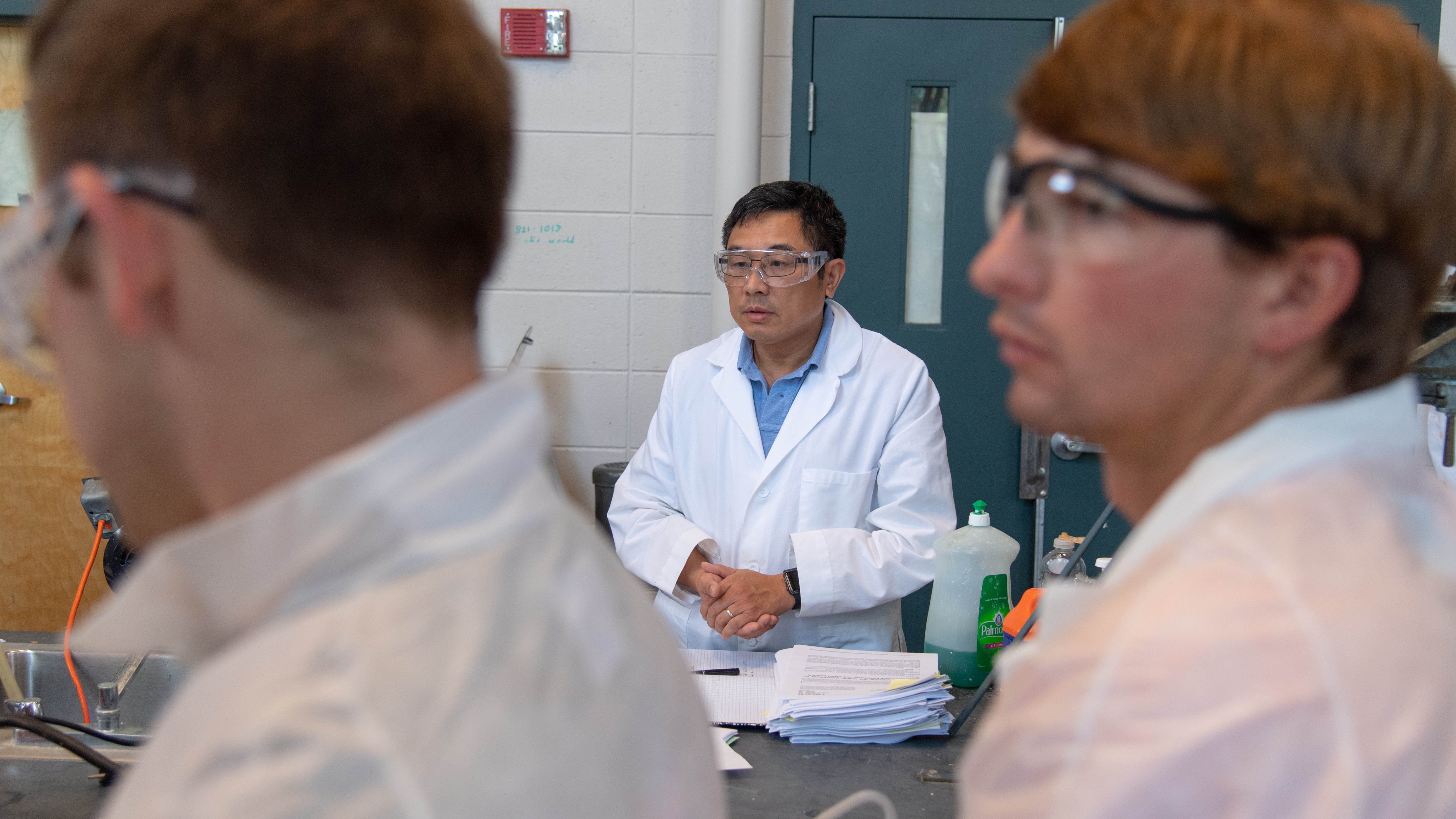 APPF Director Zhihua Jiang, assistant professor of chemical engineering in the Samuel Ginn College of Engineering, oversees students in the lab.