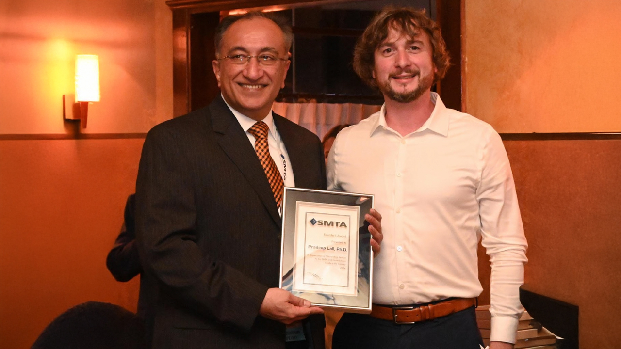 Pradeep Lall (left) was presented with the Founder’s Award by Lockheed Martin's Tom Rovere at the 2024 SMTA International Conference.