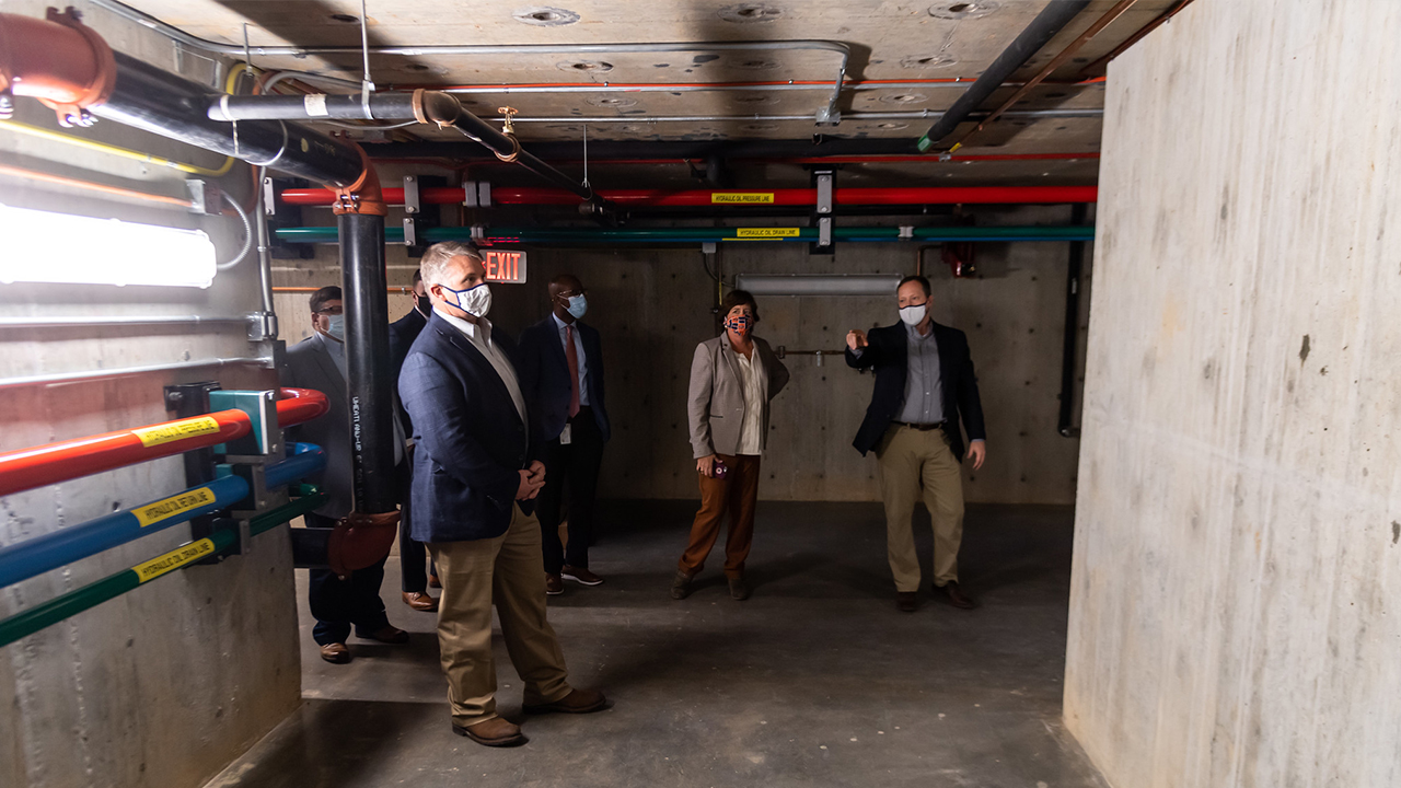 Justin Marshall (far right), director of the Advanced Structural Engineering Laboratory, shows off the facility's 4,700-cubic-foot geotechnical test chamber.   