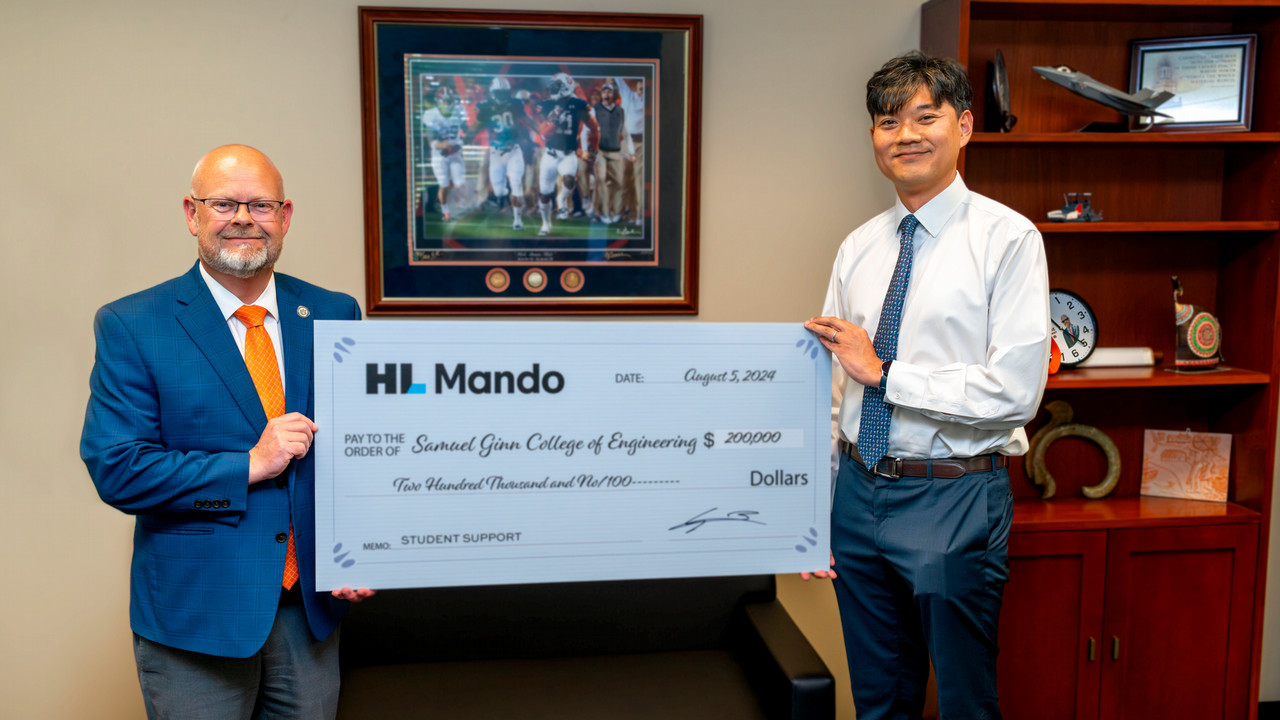 Yun Lee presenting ceremonial check to Engineering Dean Mario Eden on behalf of HL Mando America