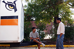 student talking at motor sports trailer