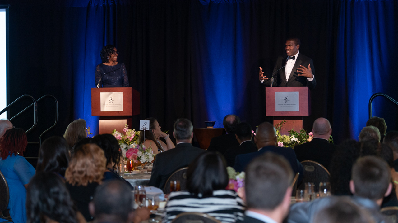 Auburn Engineering alumni Beverly Banister, '83 chemical engineering, and K-Rob Thomas, '01 civil engineering, address the crowd at the 25 Years of Excellence gala Saturday. 