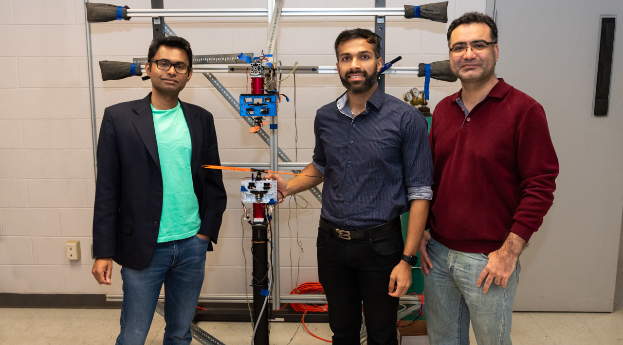 Vrishank Raghav, assistant professor in aerospace engineering (left), Lokesh Silwal, graduate student in aerospace engineering (center), and Ehsan Taheri, assistant professor in aerospace engineering, with their coaxial rotor prototype.