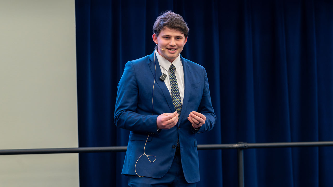 Ayden Kemp, a graduate student in biosystems engineering, presents his winning pitch, "Can plastic power airplanes?"