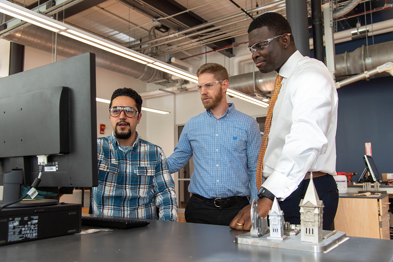 Emmanuel Winful (right) is pictured with researchers from the National Center for Additive Manufacturing Excellence.