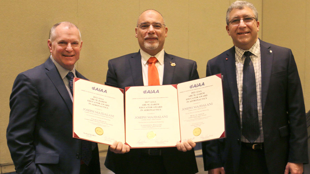 Joe Majdalani, center, with all three Abe M. Zarem Educator Award certificates, presented by J.D. McFarlan, left, vice president at Lockheed Martin, and Basil Hassan, AIAA president.