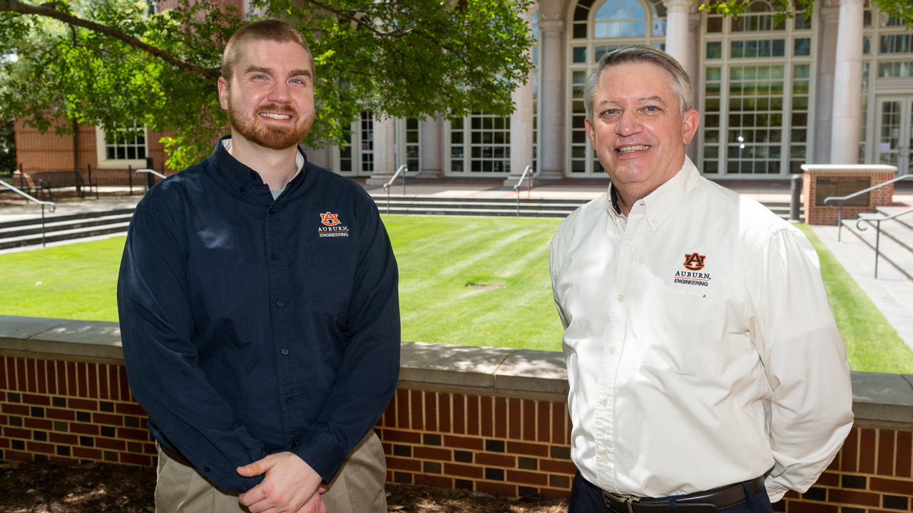 two men stand for photo outside on Auburn University's campus