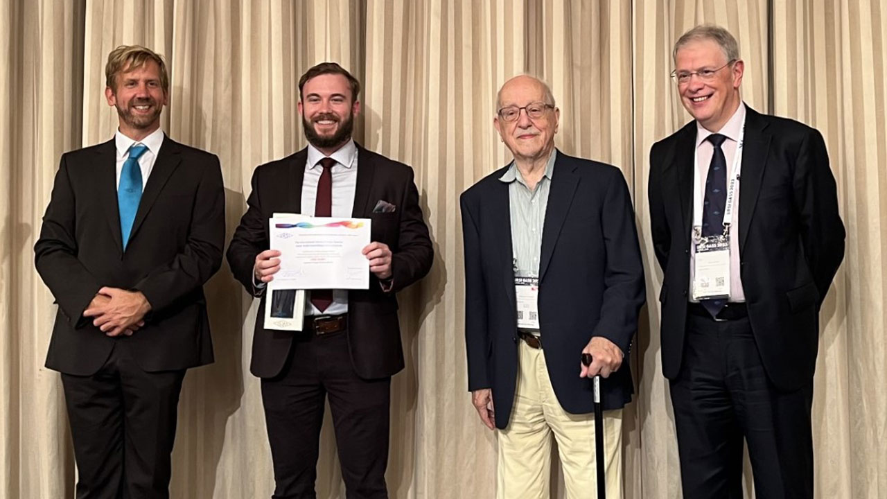 Clint Snider, second from left, was presented with the URSI-GASS Young Scientist Award in Sapporo, Japan, at its annual general assembly August 19-26. With him, from left, are URSI Assistant Secretary General Stefan Wijnholds, URSI President Piergiorgio Uslenghi, and  URSI Secretary General Peter Van Daele.