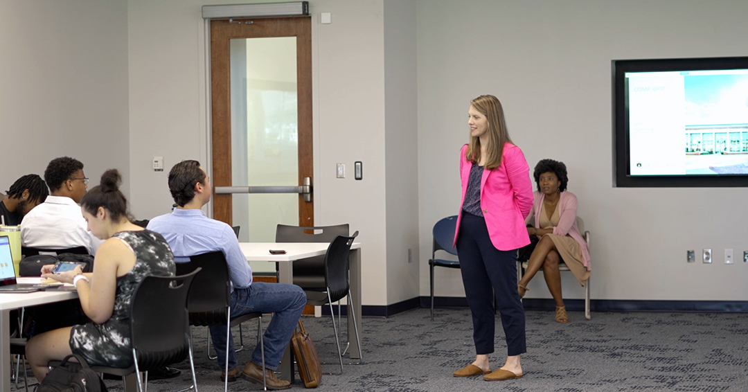 "Jessica Bowers, manager of career development content and strategy, with graduate assistant Candice Kelly (seated) introduce a career readiness assignment to Auburn Engineering students during a course facilitation session."