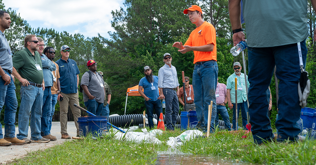Participants listen during a hands-on stormwater training demonstration at Auburn University’s Stormwater Research Facility during Stormwater Week.