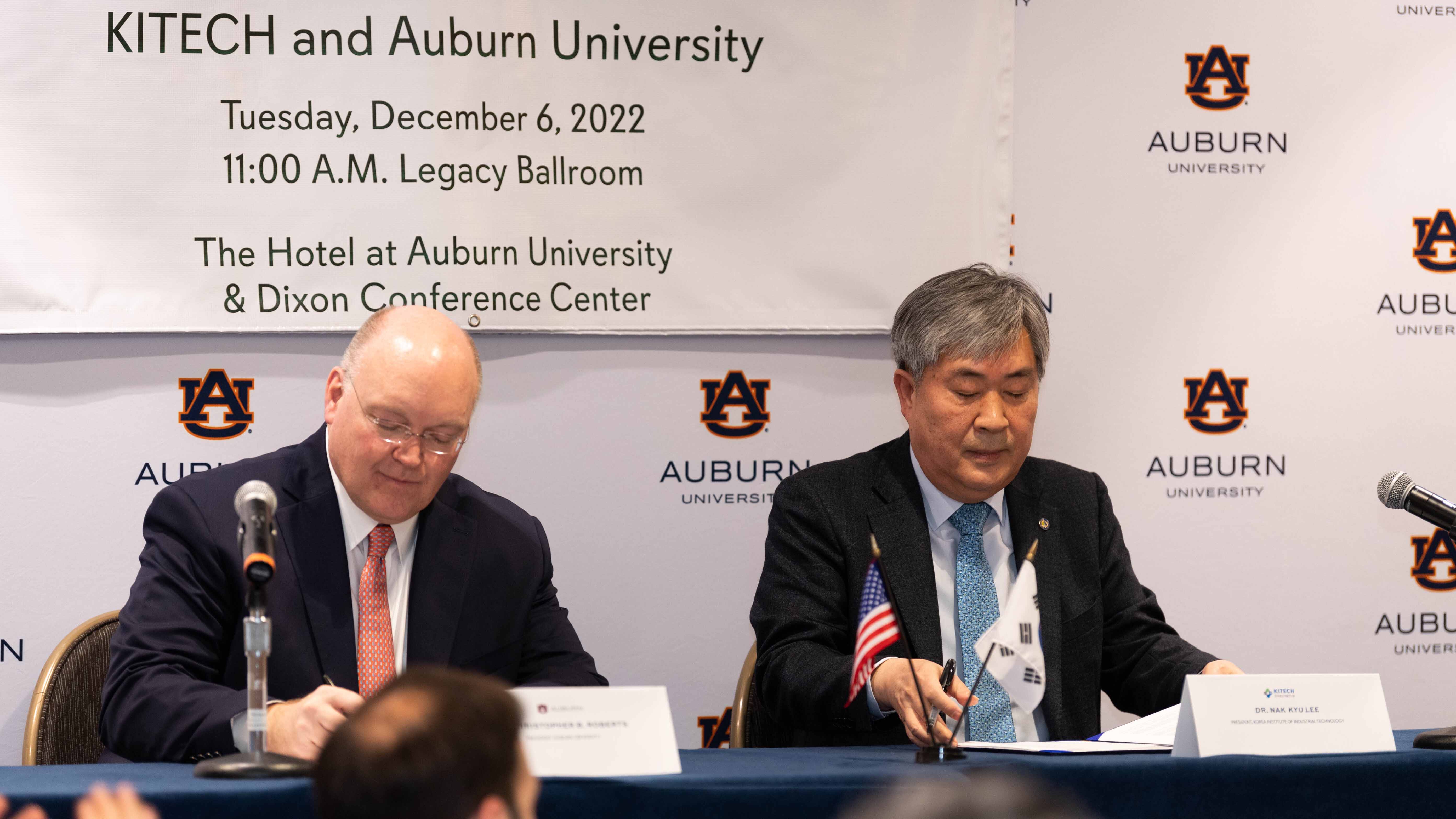 Auburn University President Christopher Roberts, left, and KITECH President Nak Kyu Lee sign the historic memorandum of understanding between the institutions Tuesday.