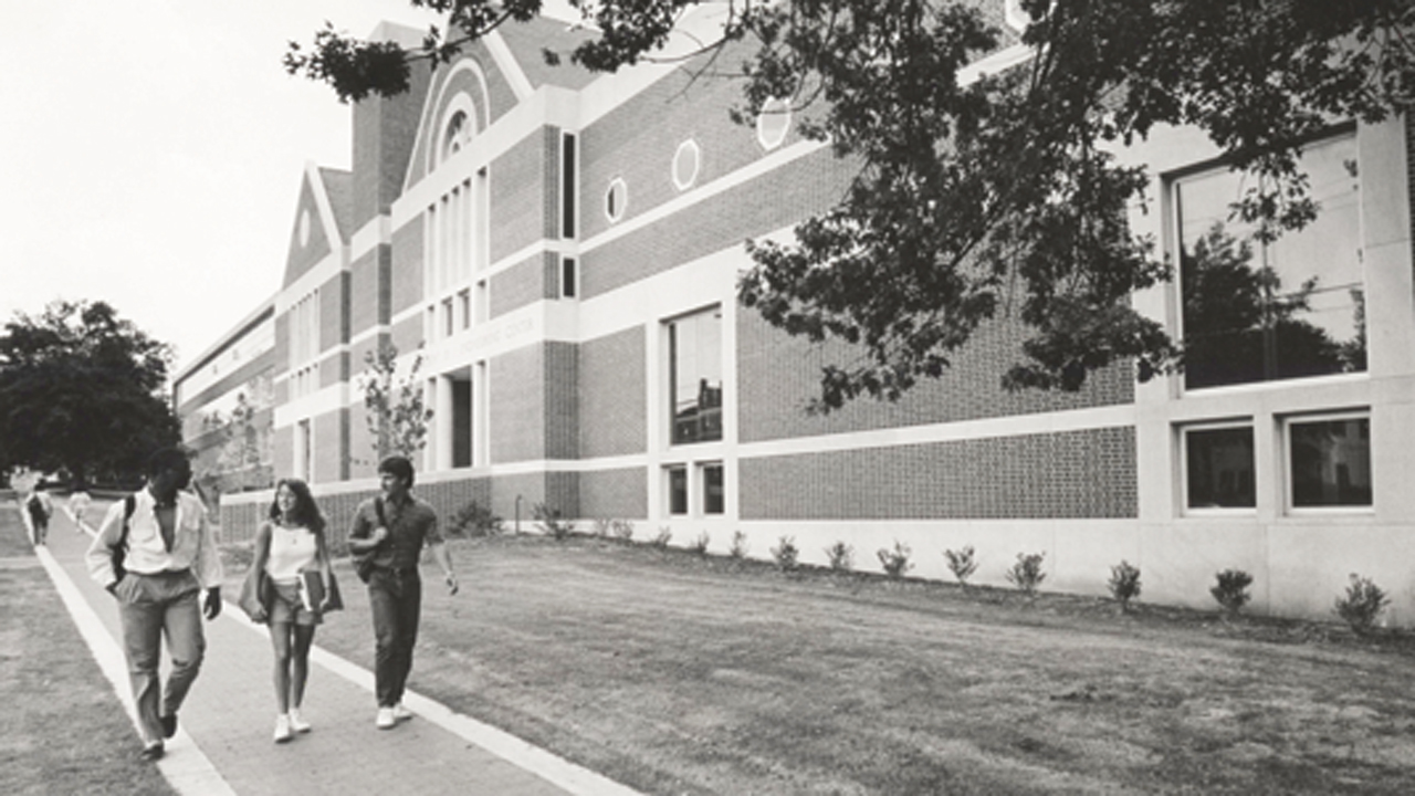 Students walk in front of the Harbert Center in the 1980s.