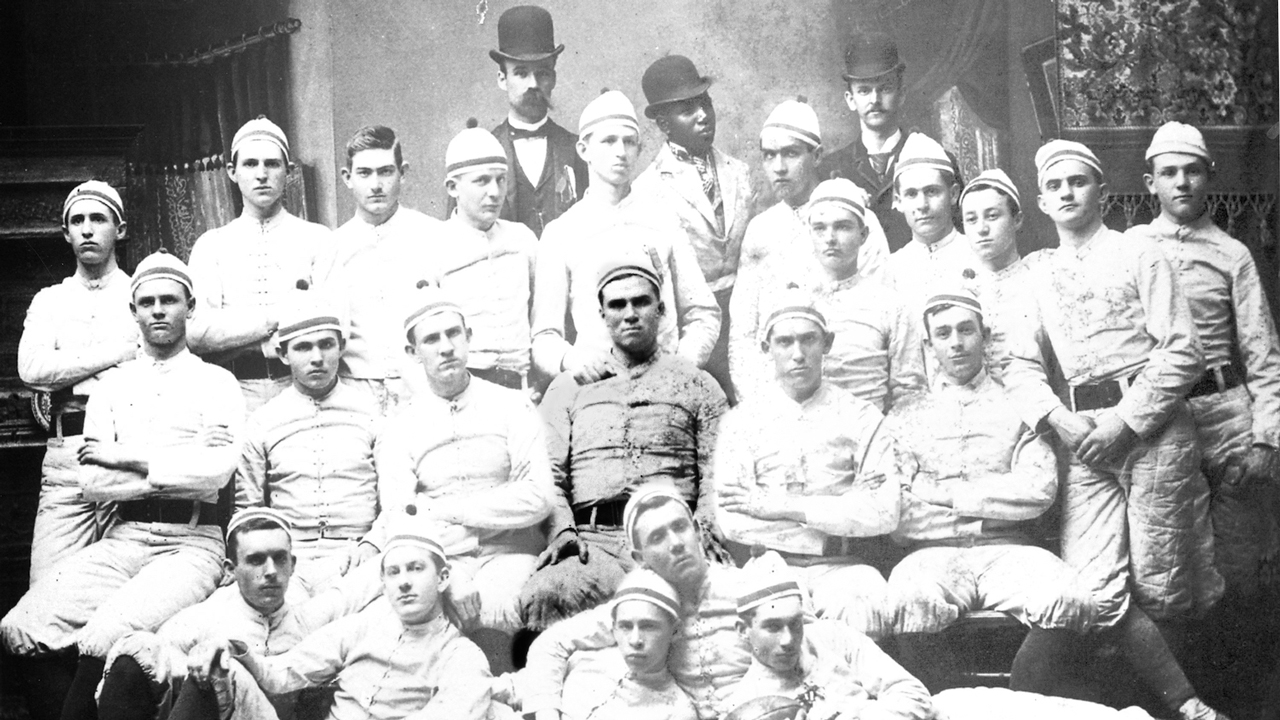 A black and white photo of the 1892 Auburn University football team with A.F. McKissick, director of Auburn's first electrical engineering laboratory, highlighted at center.