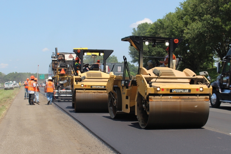 Vibratory Rollers Immediately Compact the Hot Mix Behind the Paver on I-75 near Lake City, Florida.