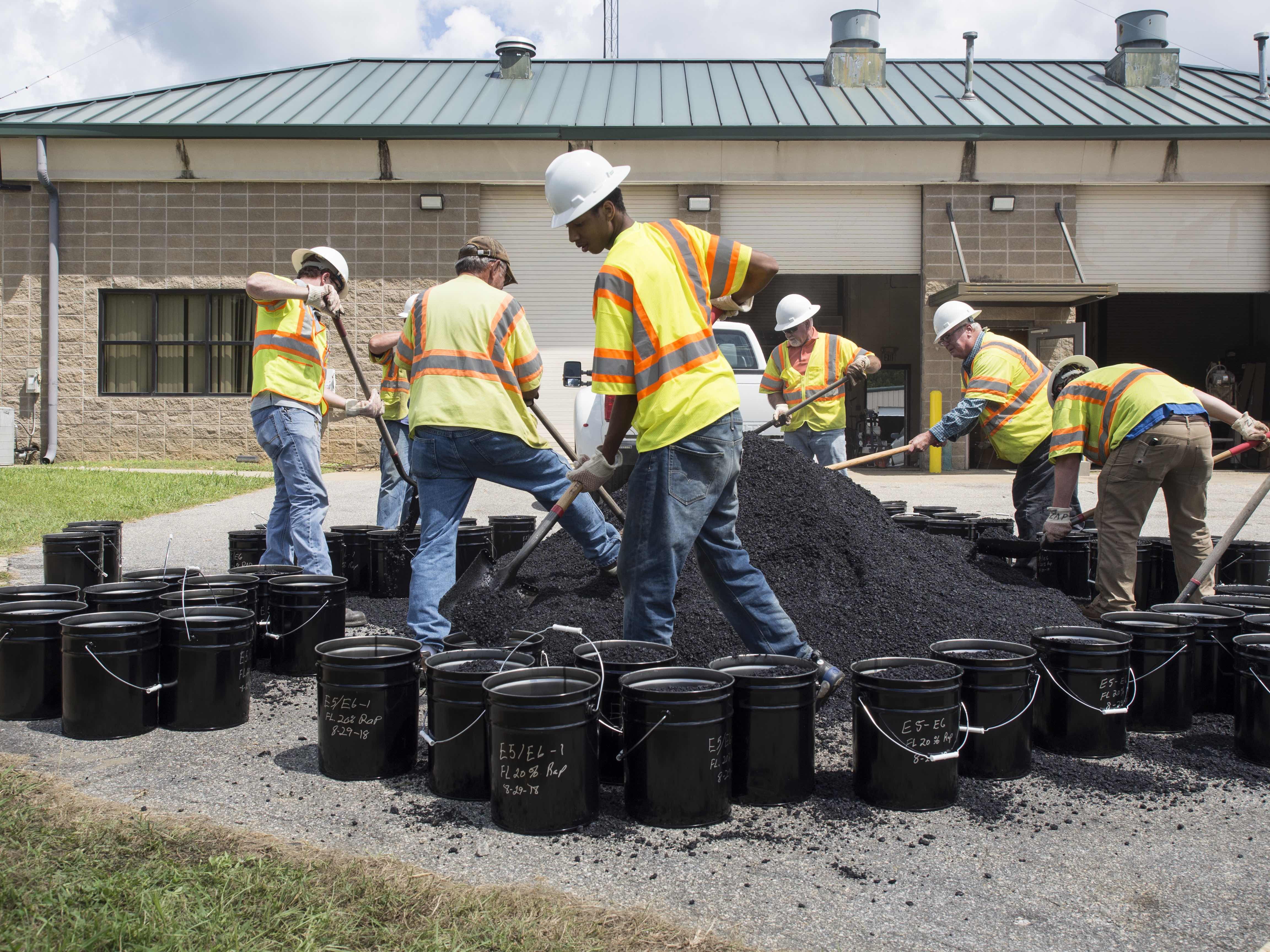 NCAT employees and students shoveled over 1000 buckets of asphalt mix during construction for laboratory testing.