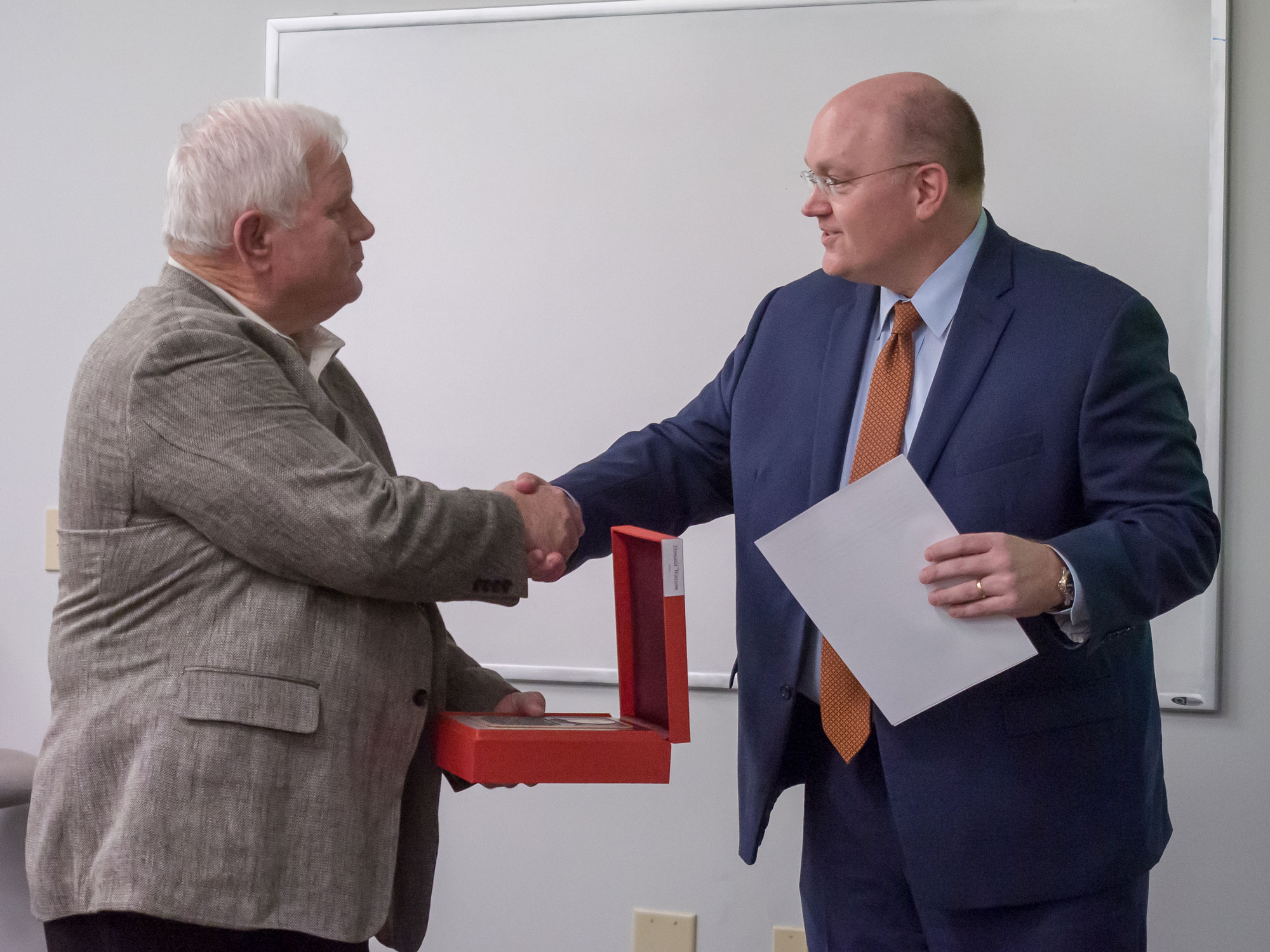 Don Watson receives the Wall of Honor plaque from Chris Roberts, NCAT board vice-chair and dean of the Samuel Ginn College of Engineering at Auburn University.