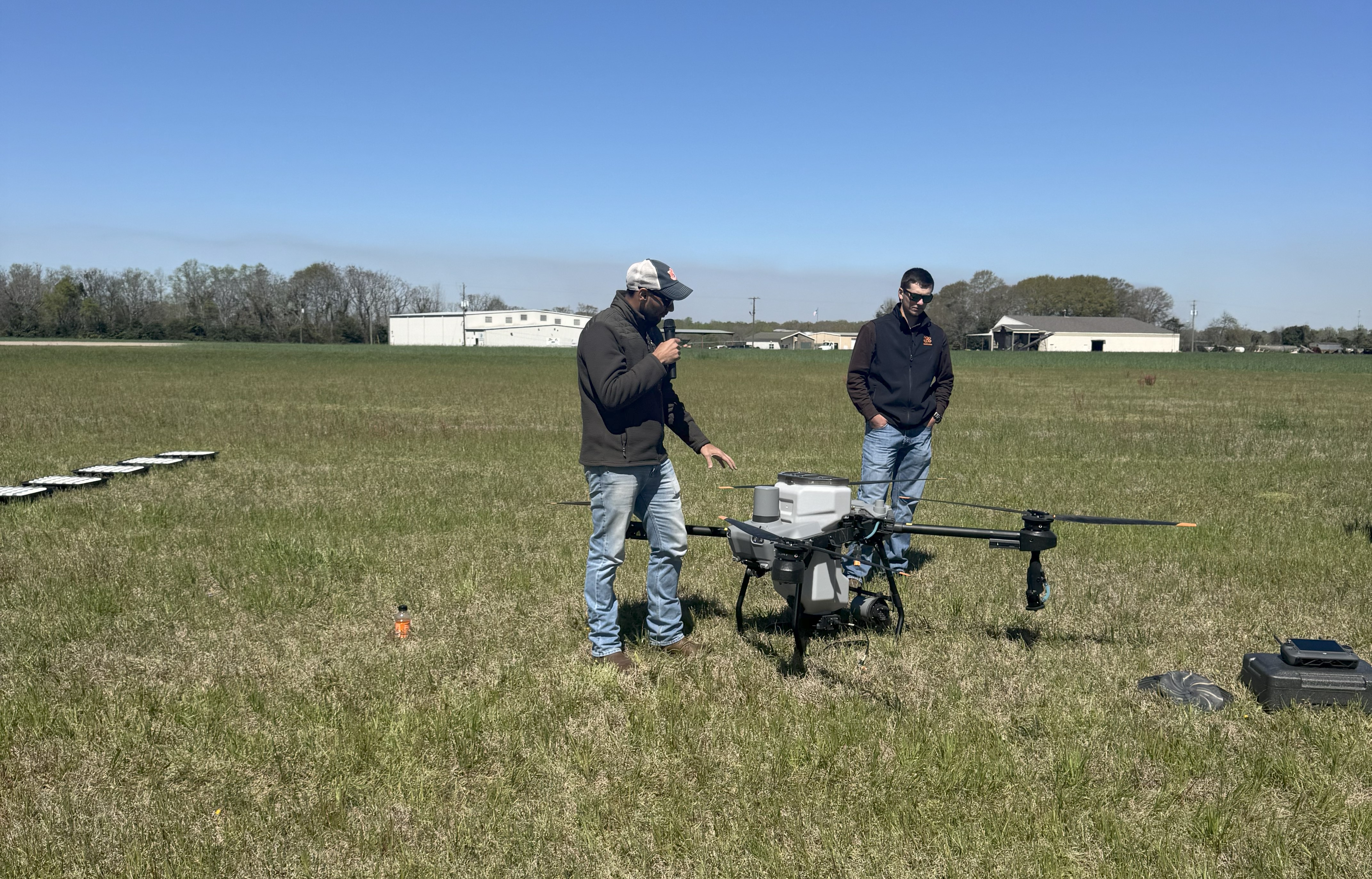 Dr. Virk and Jacob Sizemore with the sprayer drone