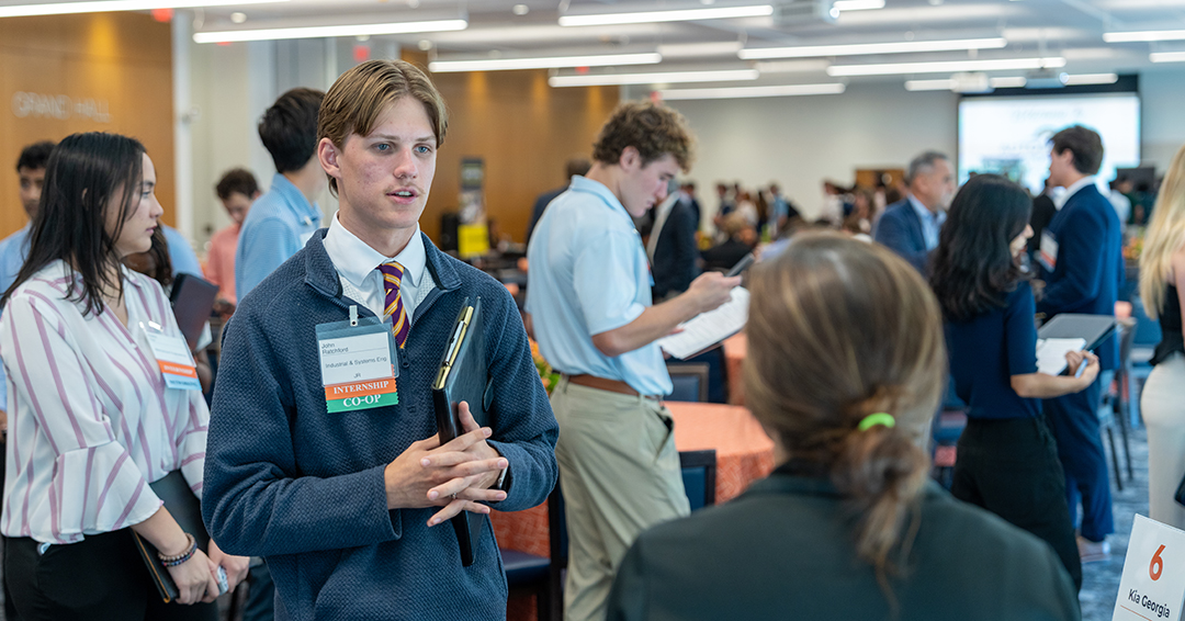 John Ratchford, a junior in industrial and systems engineering, connects with an employer representative during Automotive and Motorsports Industry Day, which brought 181 students and 13 employers together to discuss internships, co-ops and full-time career opportunities.