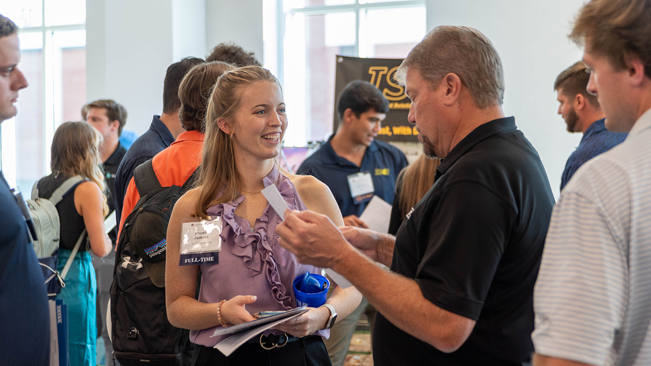 Phoebe Judkins, a student in civil and environmental engineering, talks with employers during a career fair hosted by the College of Engineering’s Career Development and Corporate Relations office in October 2023. 