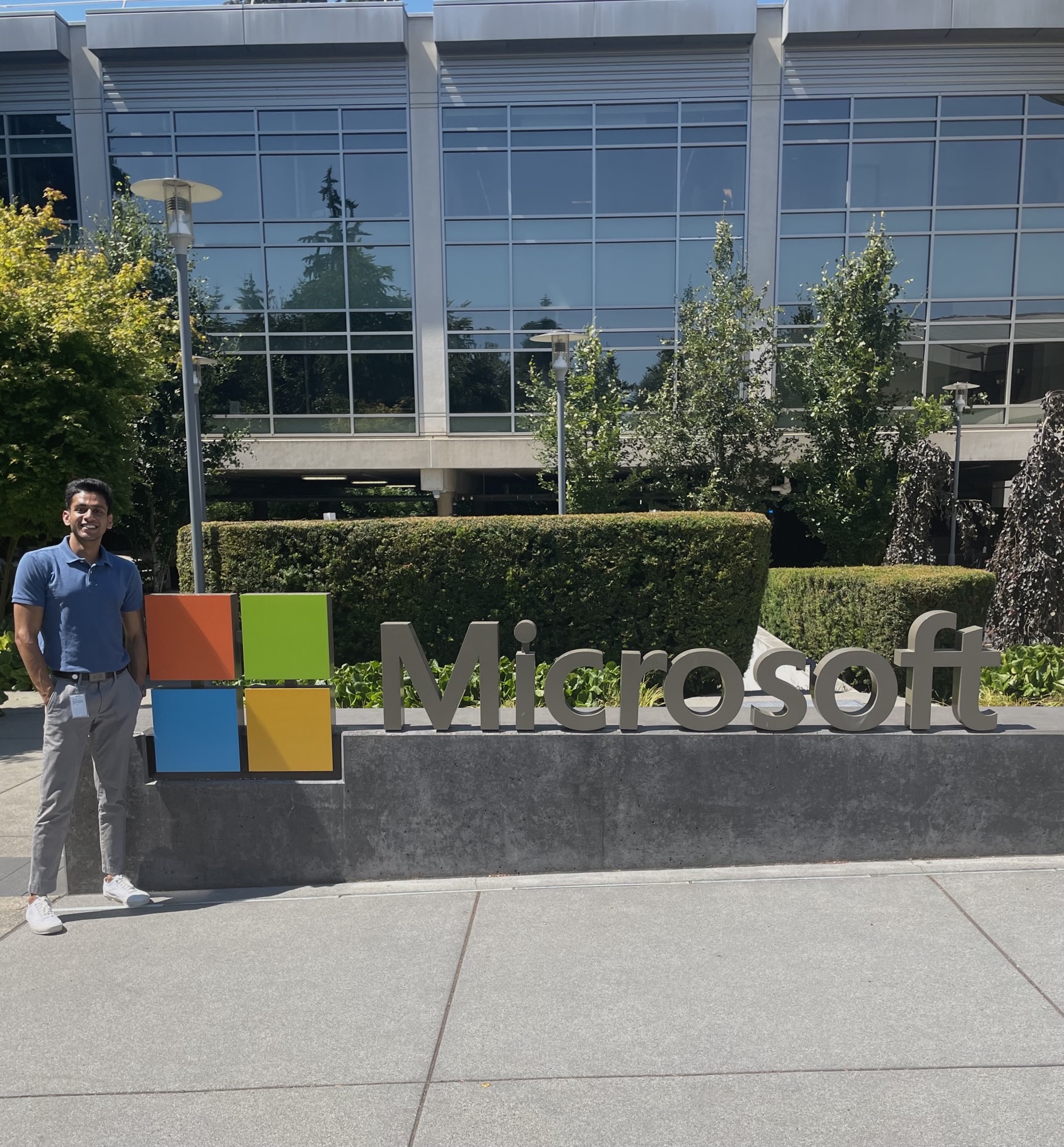 intern in front of microsoft sign