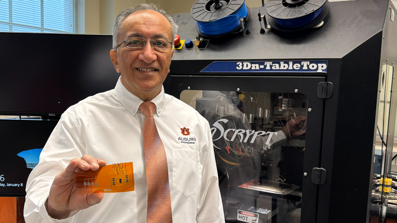 Pradeep Lall, director of the Auburn University Electronics Packaging Research Institute, displays additive electronics for automotive applications.
