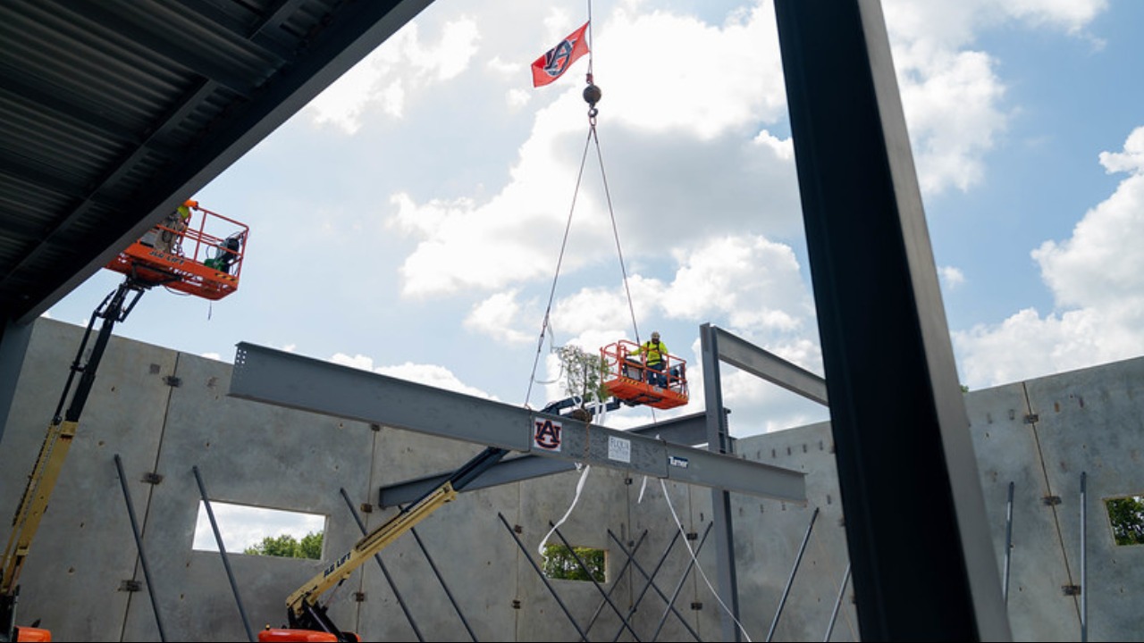 Turner Construction Company workers place the final beam atop new 50,000-square-foot addition to the Auburn University Applied Research Institute (AUARI) in Cummings Research Park. 