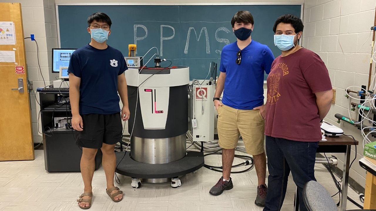 Students are pictured with the Quantum Design Physical Property Measurement System (PPMS) DynaCool in Broun Hall.