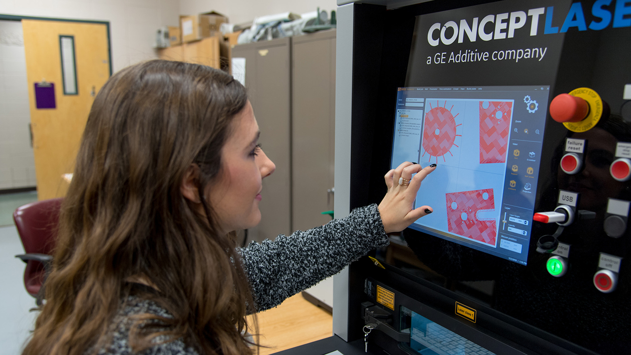 Mechanical engineering student Jennifer Matis uses the Concept Laser MLAB 100R metal printer. 