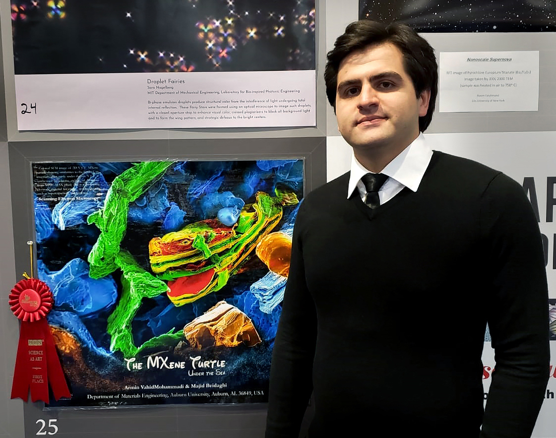 Armin VahidMohammadi poses with "The MXene Turtle Under the Sea," which won First Place in the 2018 Fall MRS Science as Art competition.