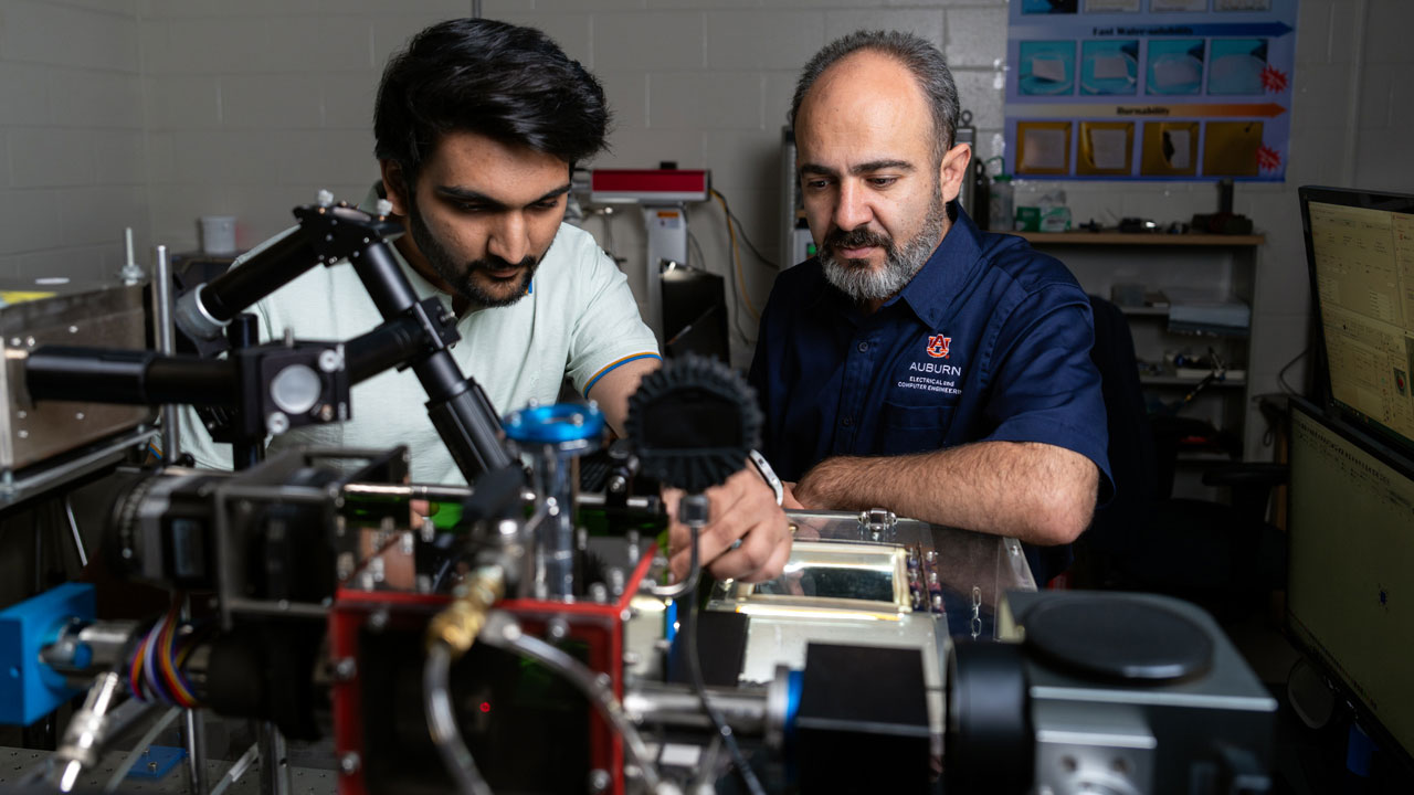 Masoud Mahjouri-Samani, associate professor of electrical and computer engineering, works with graduate student Aarsh Patel, left.