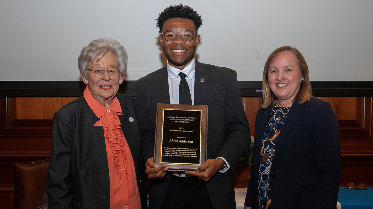 Aidan Anderson, center, with Alabama Gov. Kay Ivey, left, and Alabama Department of Rehabilitation Services Commissioner Jane Elizabeth Burdeshaw.