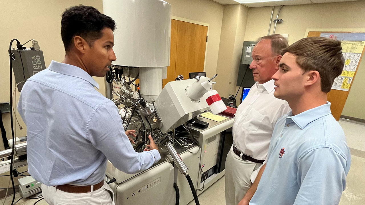 Chemical engineering graduate students Felix Mendoza, left, and Jacob Faulkner discuss upcoming research strategies with Center for Microfibrous Materials Manufacturing Director Bruce Tatarchuk.