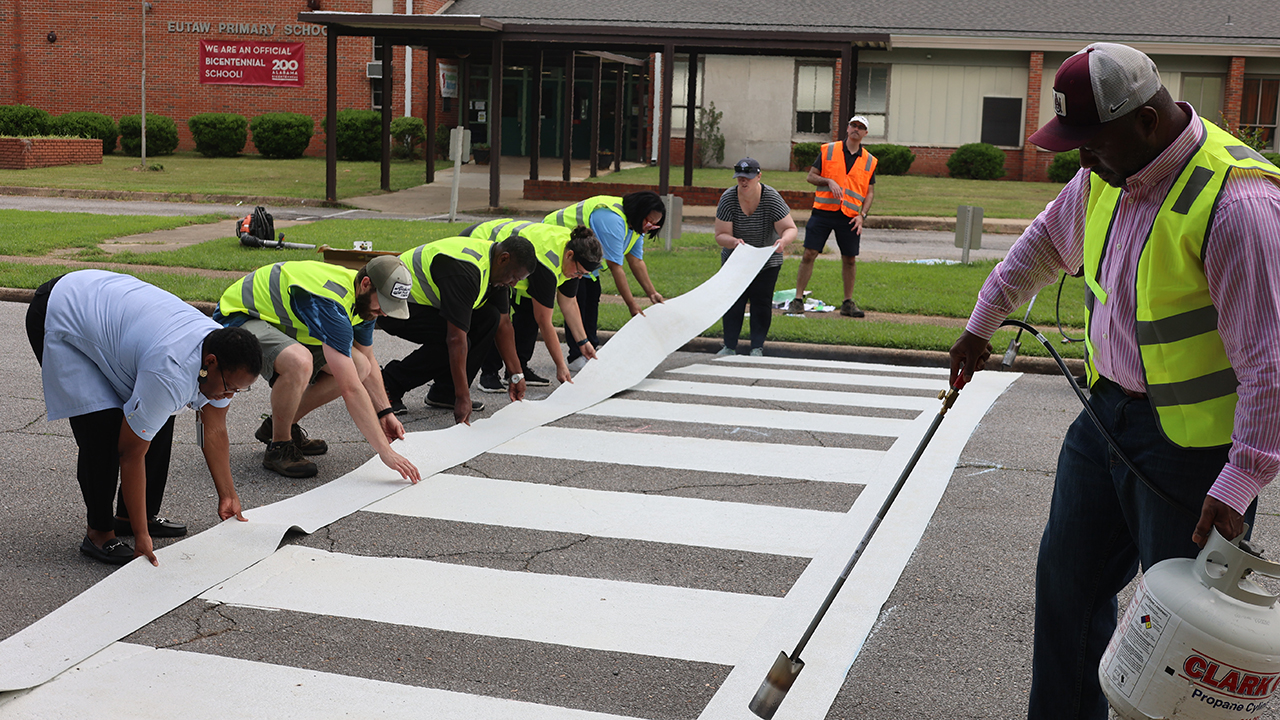 Jeff LaMondia, a civil and environmental engineering professor, coordinates the installation of a crosswalk at Eutaw Primary School in Greene County.