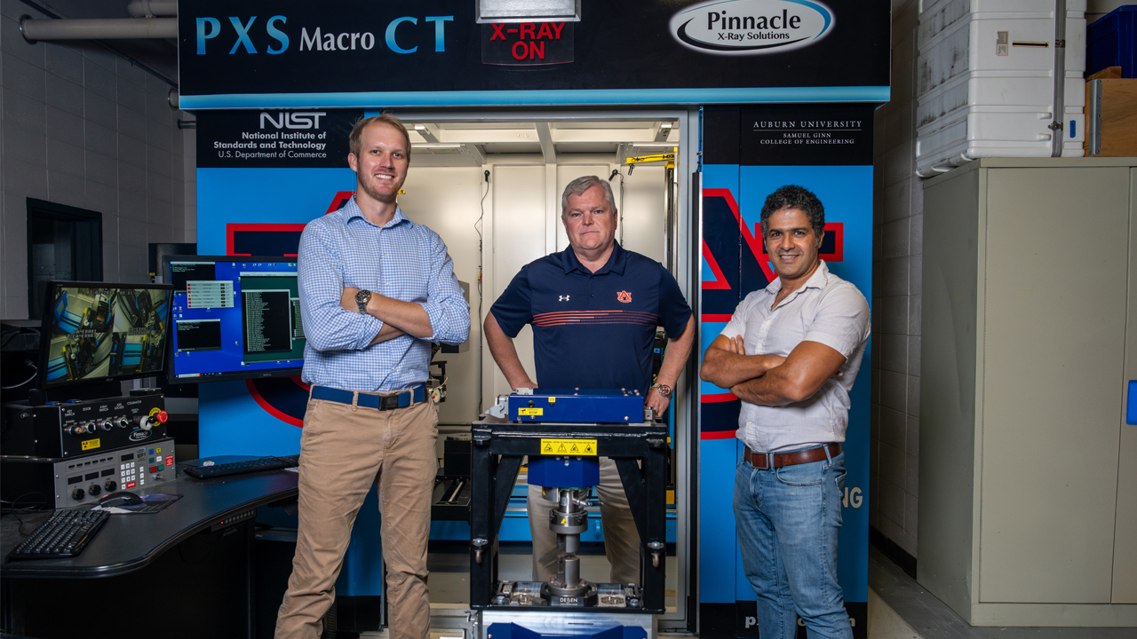 Ali Khosravi, assistant professor in civil and environmental engineer (right), Bart Prorok, a materials engineering professor (middle), and Paul Bartley, an assistant professor in horticulture at Auburn University (left) stand in front of the PSX Macro CT machine in the X-ray Computed Tomography Lab. 