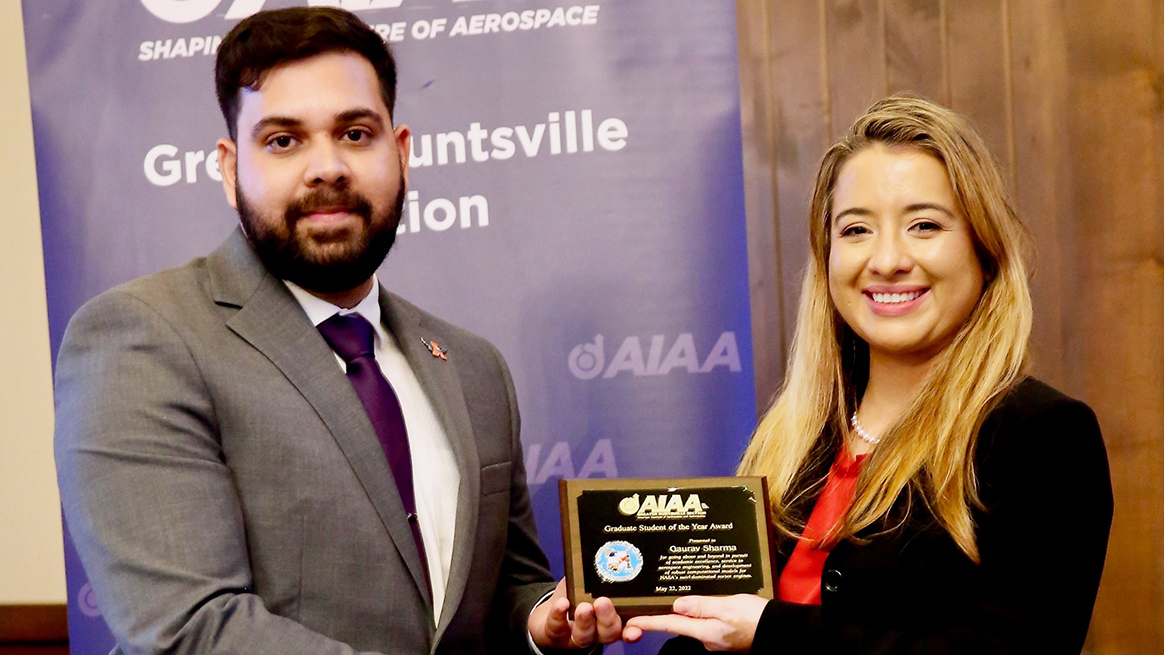 Gaurav Sharma receives the Graduate Student of the Year award from Theresa Jehle, Greater Huntsville Section Chair, at the awards ceremony in Huntsville on May 22.