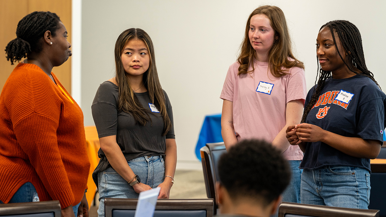 Four students talk to each other